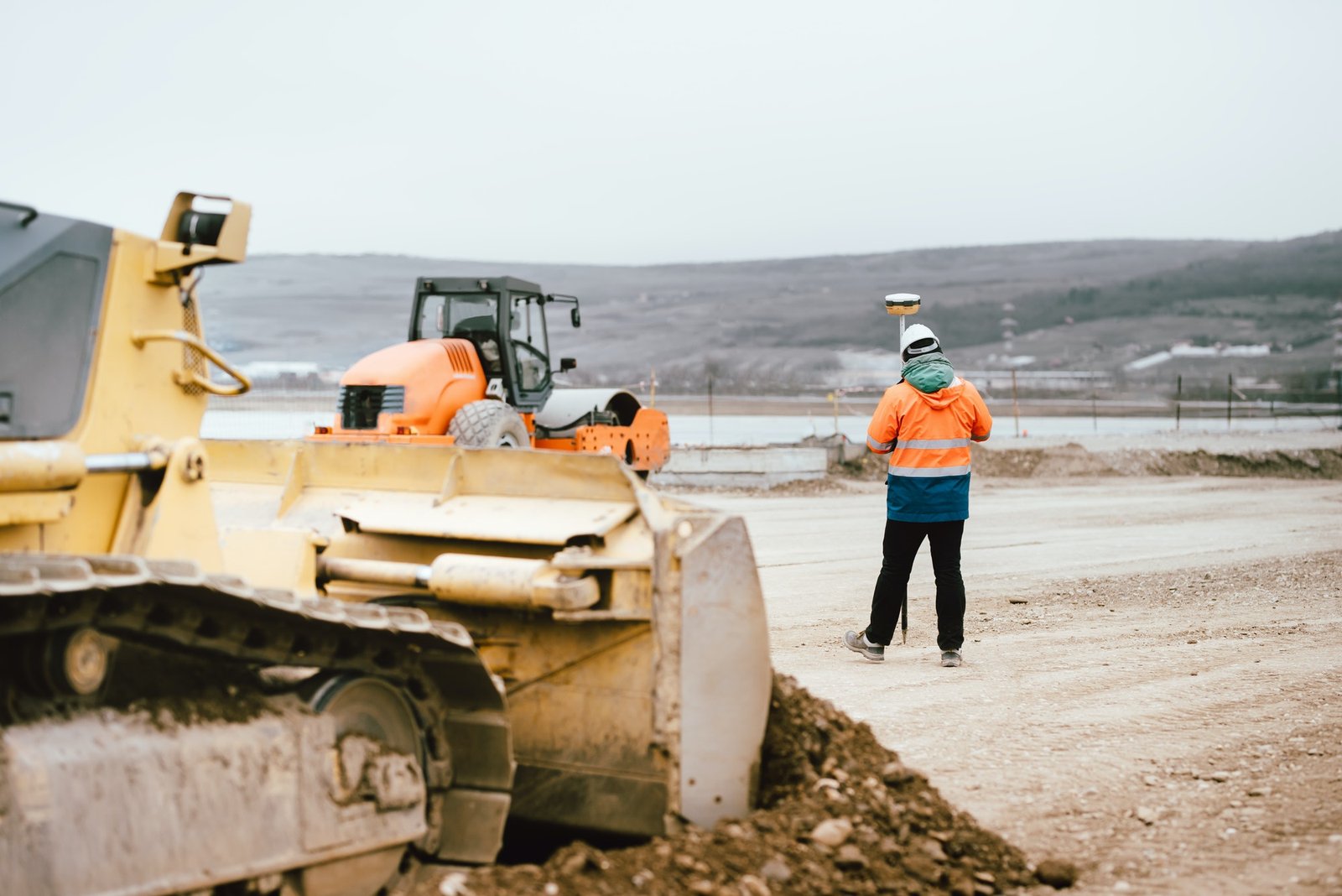 surveyor-engineer-with-gps-system-outdoors-at-highway-construction-site.jpg